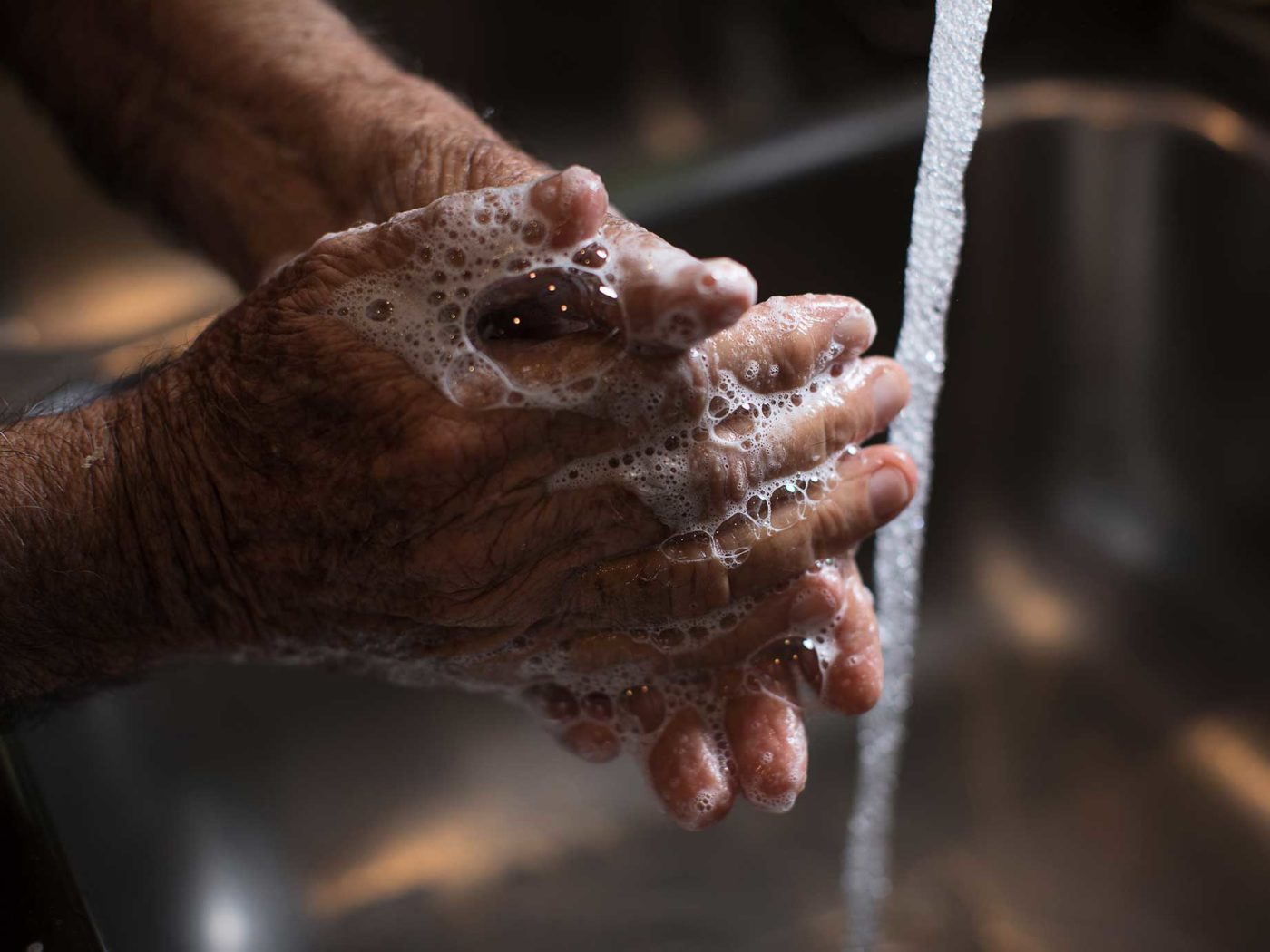 Washing hands with soap and water.